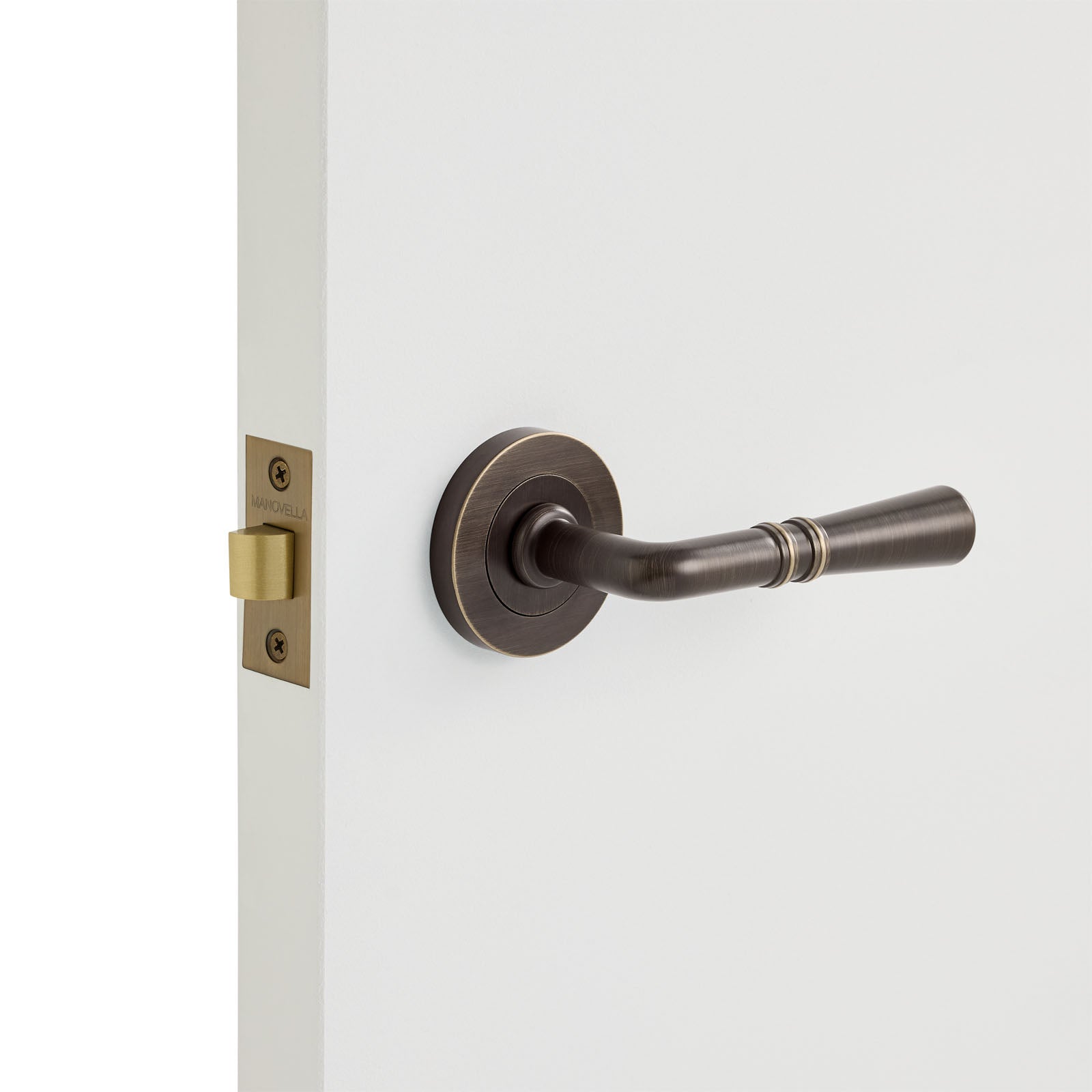 Aged Brass Passage Door Handle Installed on a Door