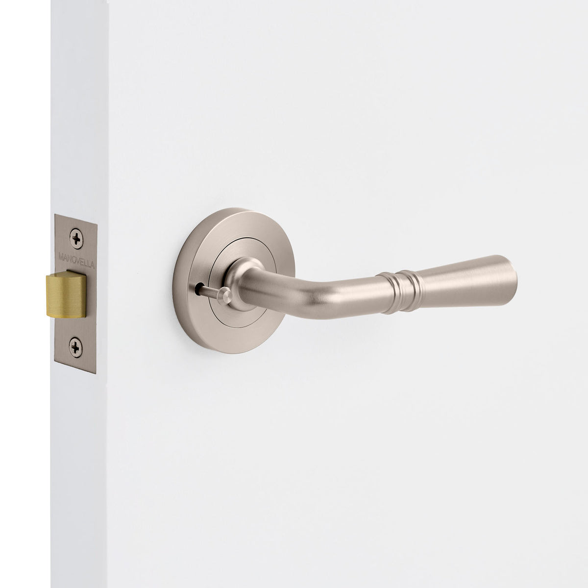 Door handle on a white door with a brushed nickel finish