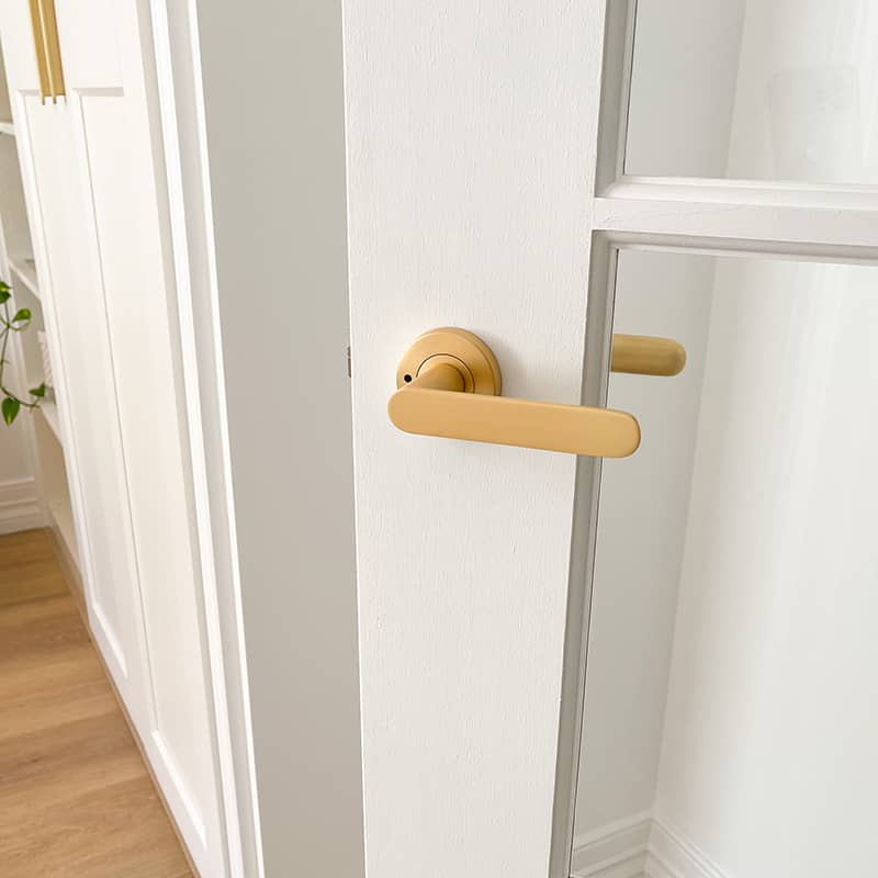 Satin Brass Fairhaven Installed on White Door with glass insert