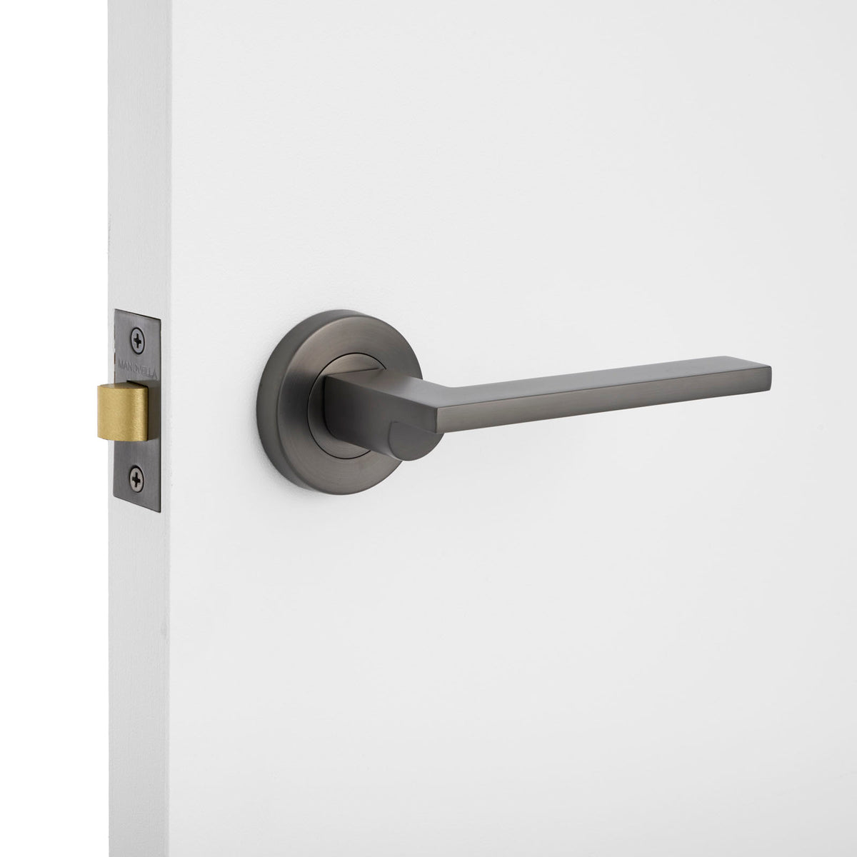 Modern door handle on a white door with a neutral background