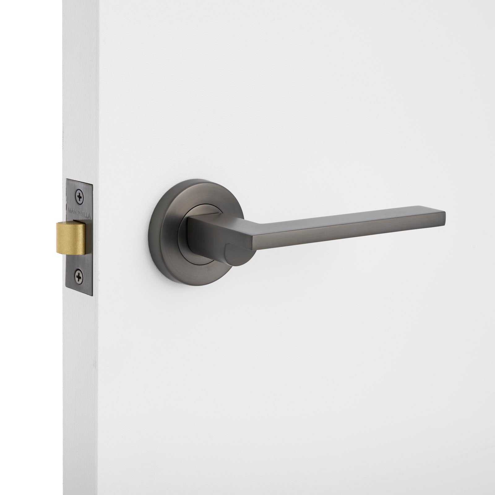 Modern door handle on a white door with a neutral background
