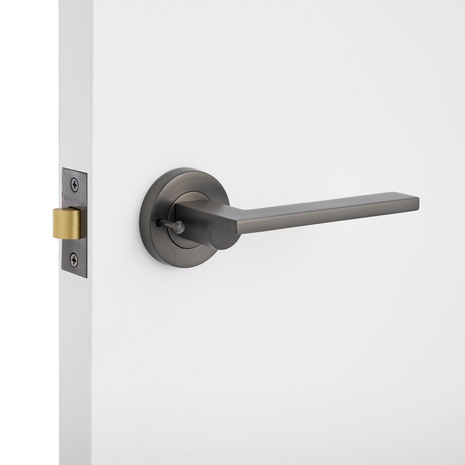 Modern door handle on a white door with a light gray background