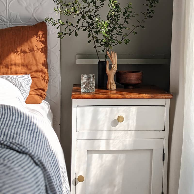 Brushed Brass Olivia installed on white bed side table with morning sun