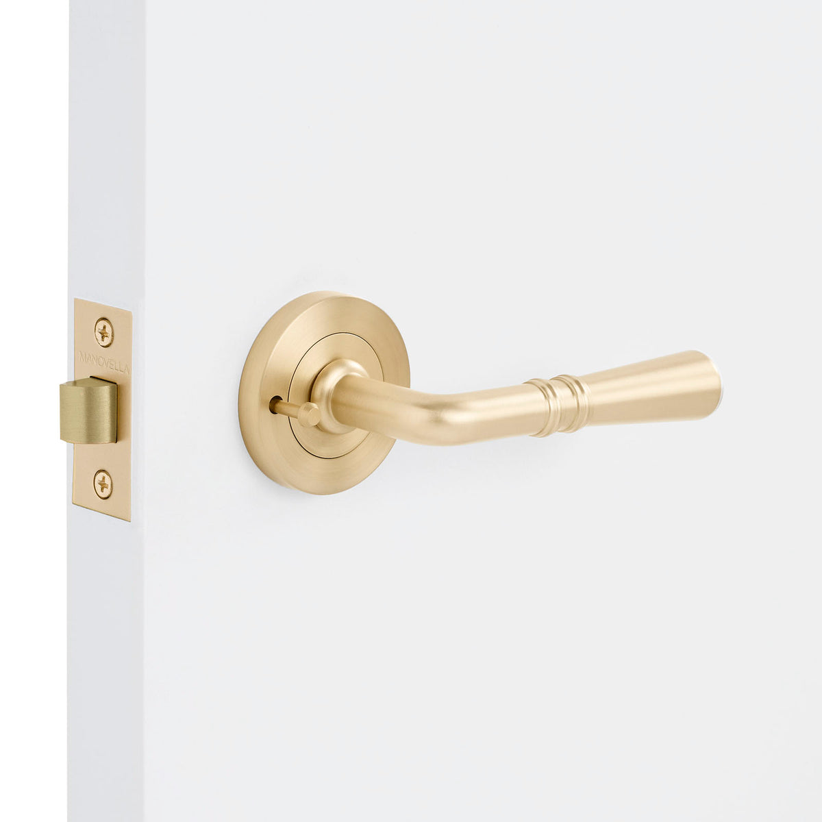 Gold door handle on a white door